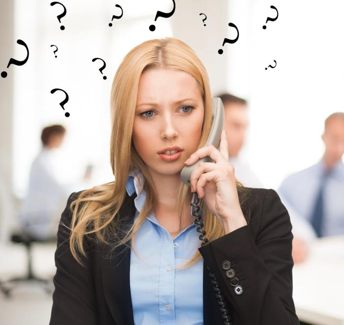 woman holding a phone with question marks floating above her head