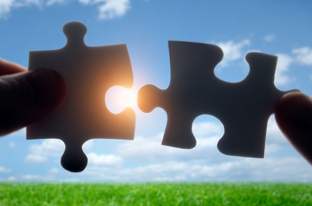 Matching puzzle pieces against a sky background