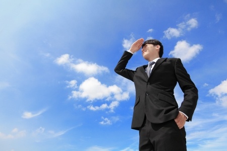 Man looking off in distance with big blue sky