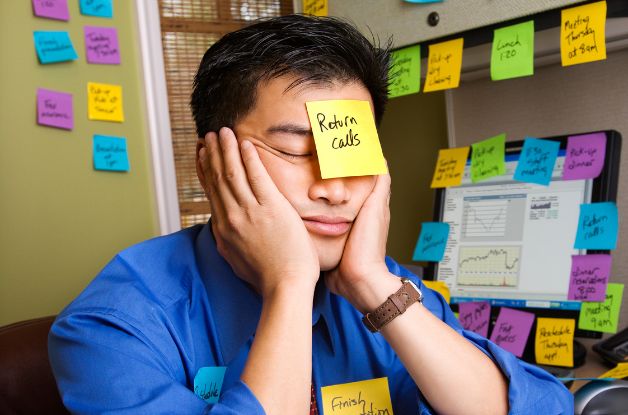 A man with sticky notes everywhere who should be using Actions in Rosemark