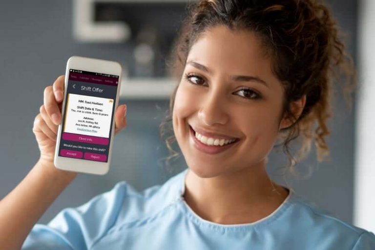 Caregiver showing off the Rosemark System caregiver mobile app for evv