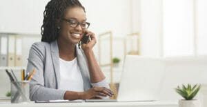 happy woman in office on phone