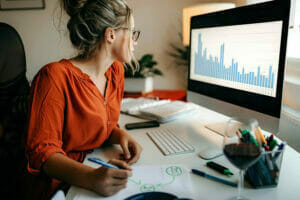 businesswoman review trends on graph