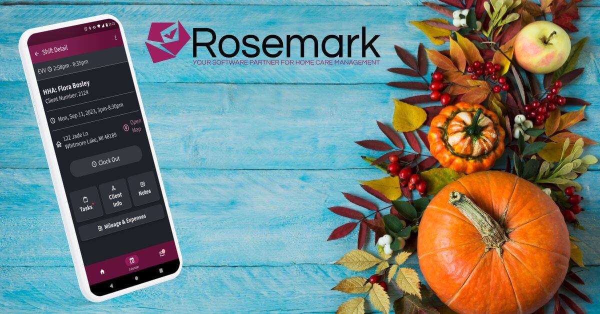 fall background with fall flowers and pumpkins overlaid with a cell phone displaying the Rosemark Caregiver APp