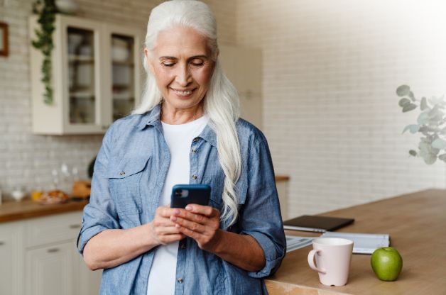 Caregiver clocking into her shift through an electronic visit verification app on her cell phone