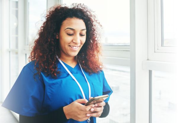 caregiver clocking into her shift using the Rosemark Caregiver App so her home care agency is compliant with Michigan EVV