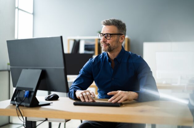 A man at a computer looking for information on AI in home care