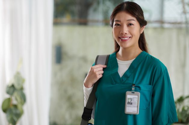 Professional home care agency caregiver with an identification badge, representing successful EVV compliance and mobile clock-in standards. 