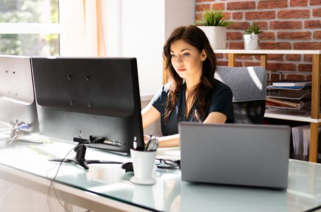 Home care agency owner reviewing operational data and scheduling metrics on a desktop computer